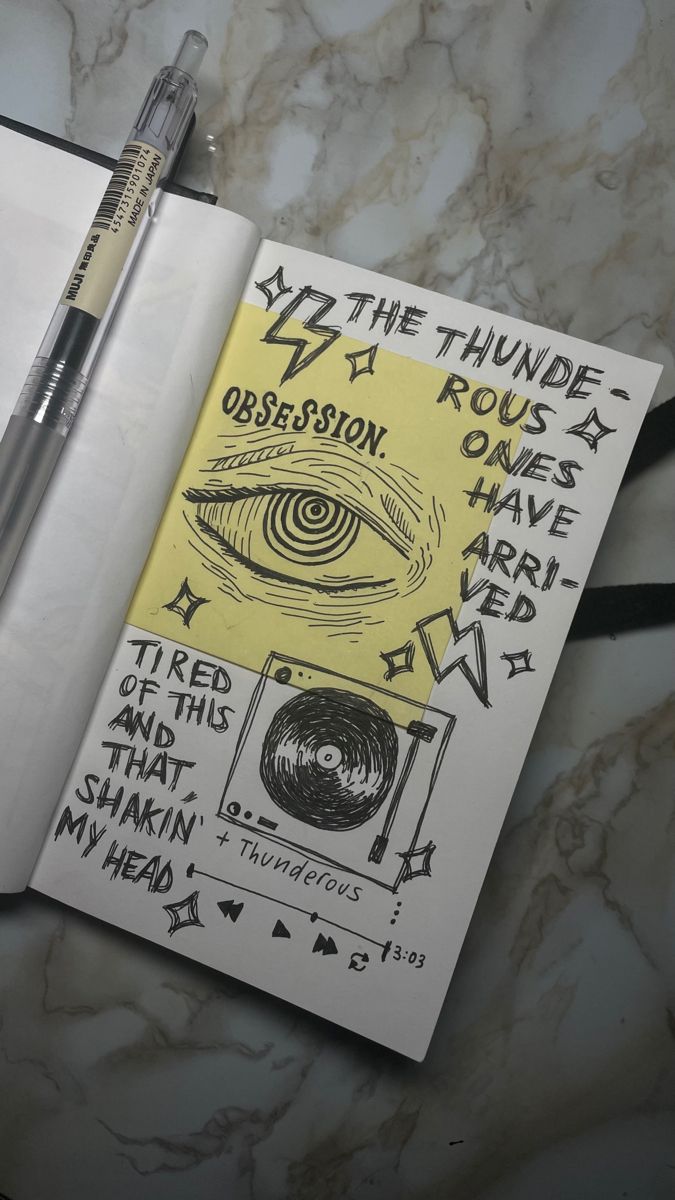 a notebook with some writing on it next to a pen and eyeball marker,