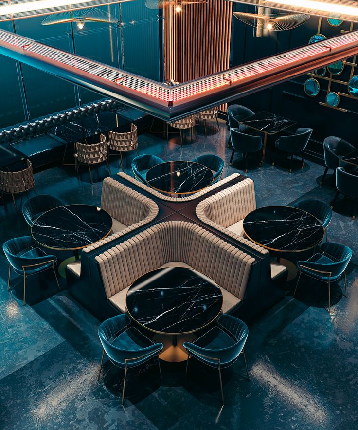 the interior of a modern restaurant with black and gold chairs, tables, and mirrors