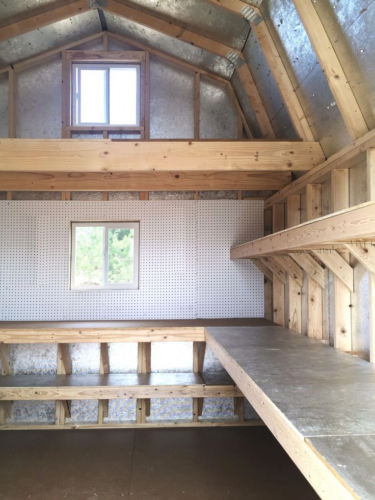 an empty room with some shelves and windows