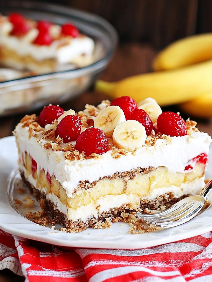 a piece of cake with bananas and cherries on top is sitting on a plate