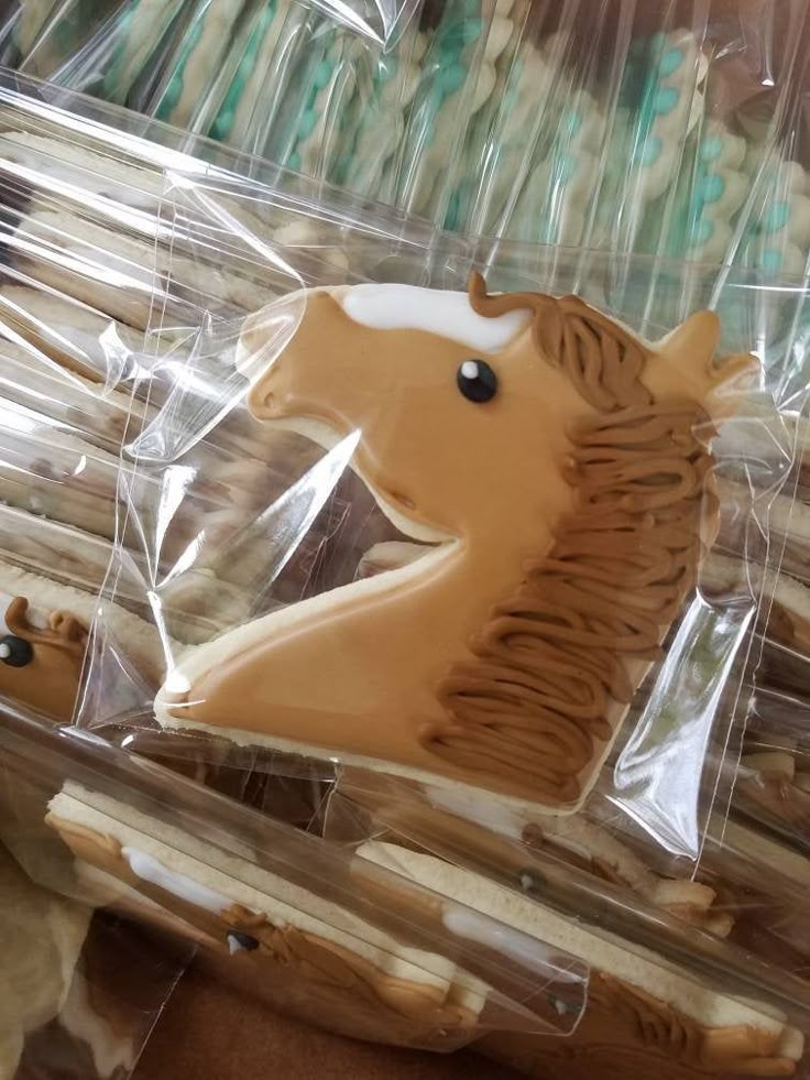 some cookies shaped like horses in plastic bags