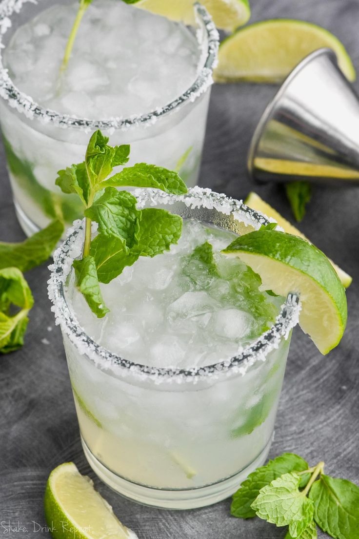 two margaritas garnished with mint and lime