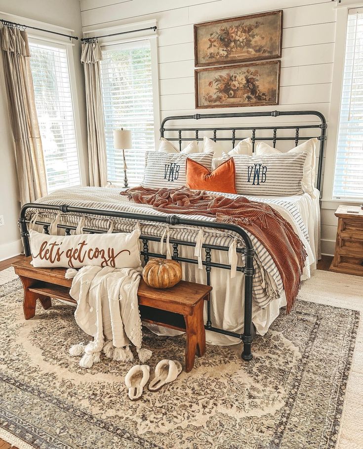 a bed room with a neatly made bed and a rug on the floor next to it