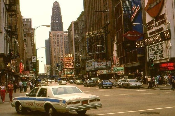 a police car driving down a busy city street