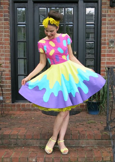 a woman in a colorful dress standing on steps