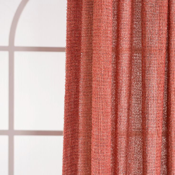 an orange curtain hanging in front of a window