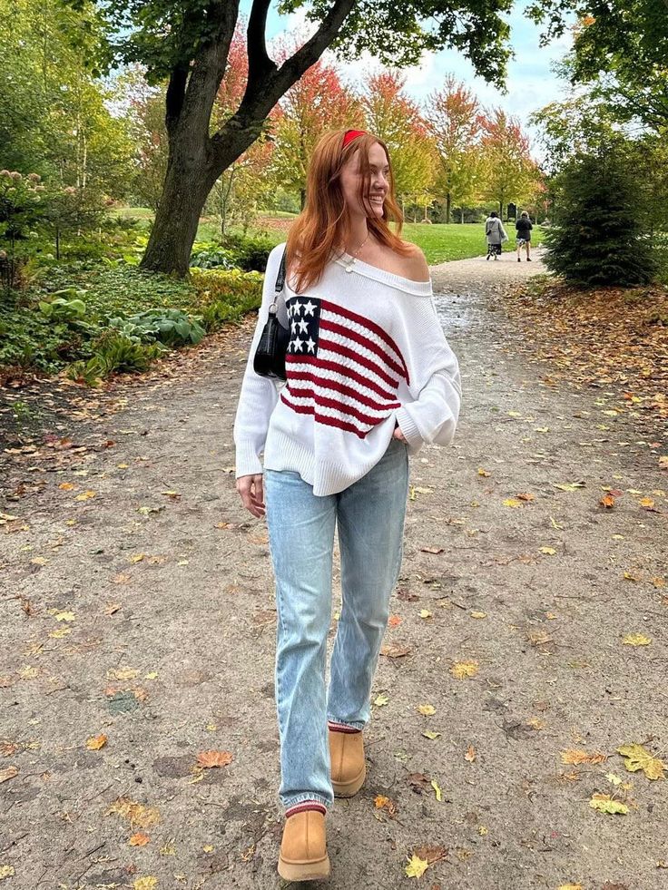 STYLE INFORMATION: Show your patriotic pride in the Land of Free White Oversized Flag Sweater! White knit fabric forms a boat neck sweater that can be worn or slouchy off-the-shoulder. Oversized bodice with drop shoulders and long sleeves. Features alternate knit with American flag design. Style over your favorite jeans for a cute casual look! DETAILS & CARE: 100% Cotton Hand wash cold. Imported. SHIPPING: Orders are processed within 1-2 business days. Packages are shipped out Monday-Friday, hol American Sweater, White Oversized Sweater, Flag Sweater, Nyc Fits, Usa Sweater, Boat Neck Sweater, American Flag Sweater, American Flag Design, Chill Outfits