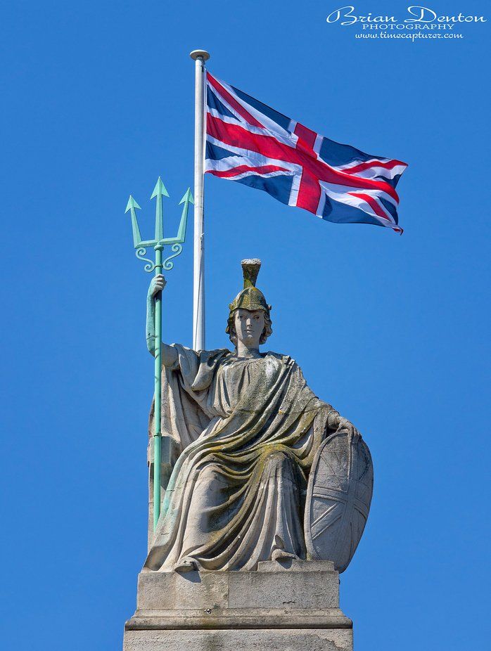 a statue with a flag on top of it