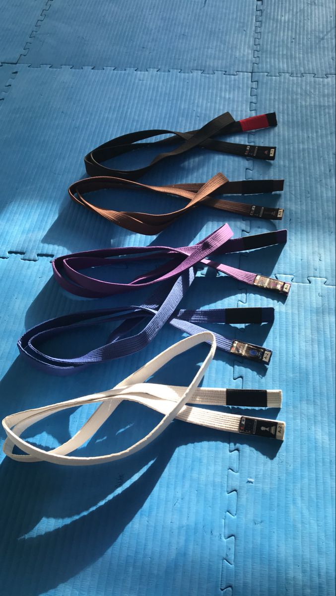 four lanyards laid out on a blue surface