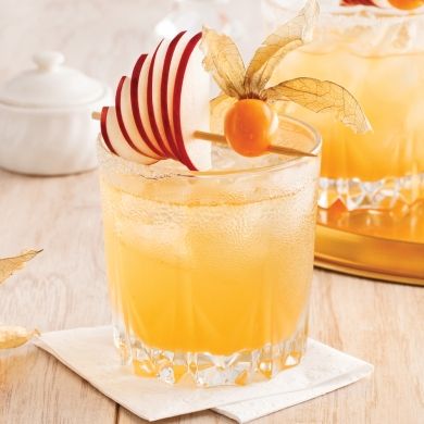 two glasses filled with drinks sitting on top of a table