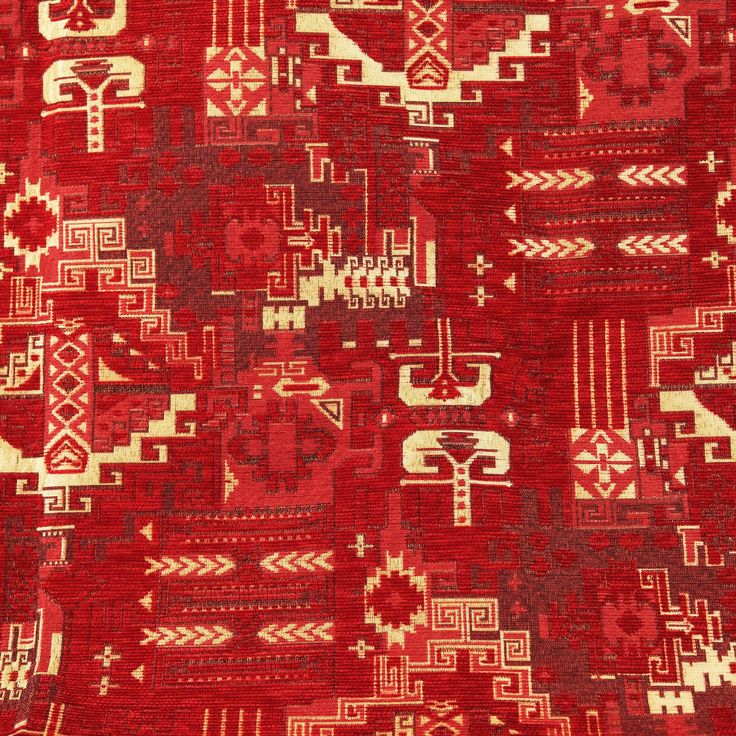 an old red rug with many different designs