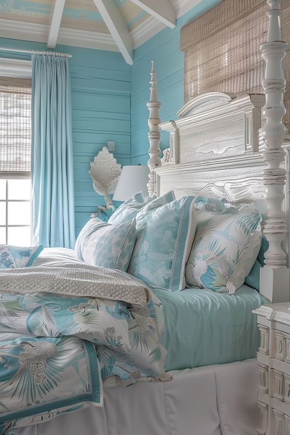 a bedroom with blue walls and white furniture