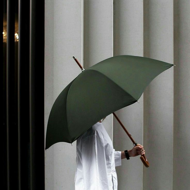 a person holding an umbrella in their hand