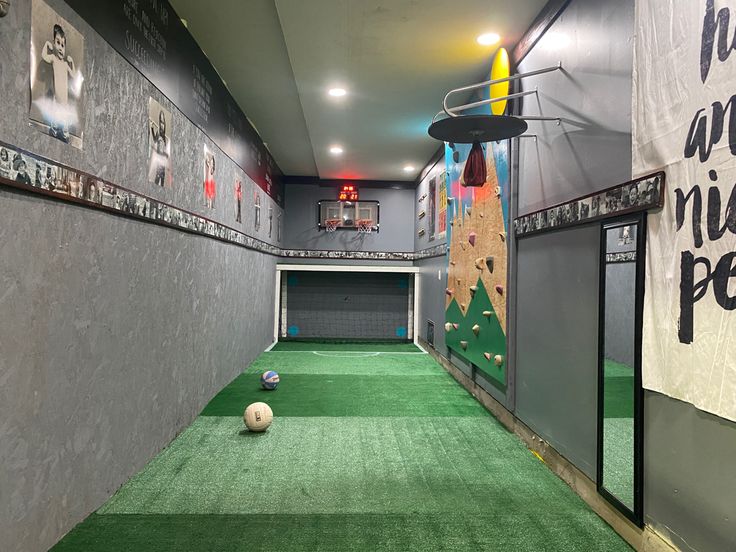 an indoor golf course with balls and tees on the green carpeted flooring