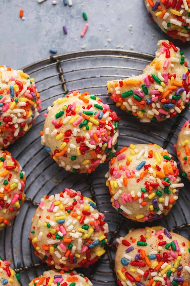 sprinkle covered donuts on a cooling rack