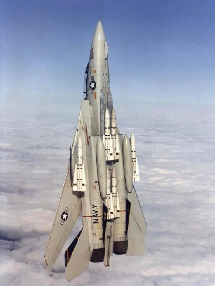 an air force jet flying through the sky above some clouds and blue sky with white clouds