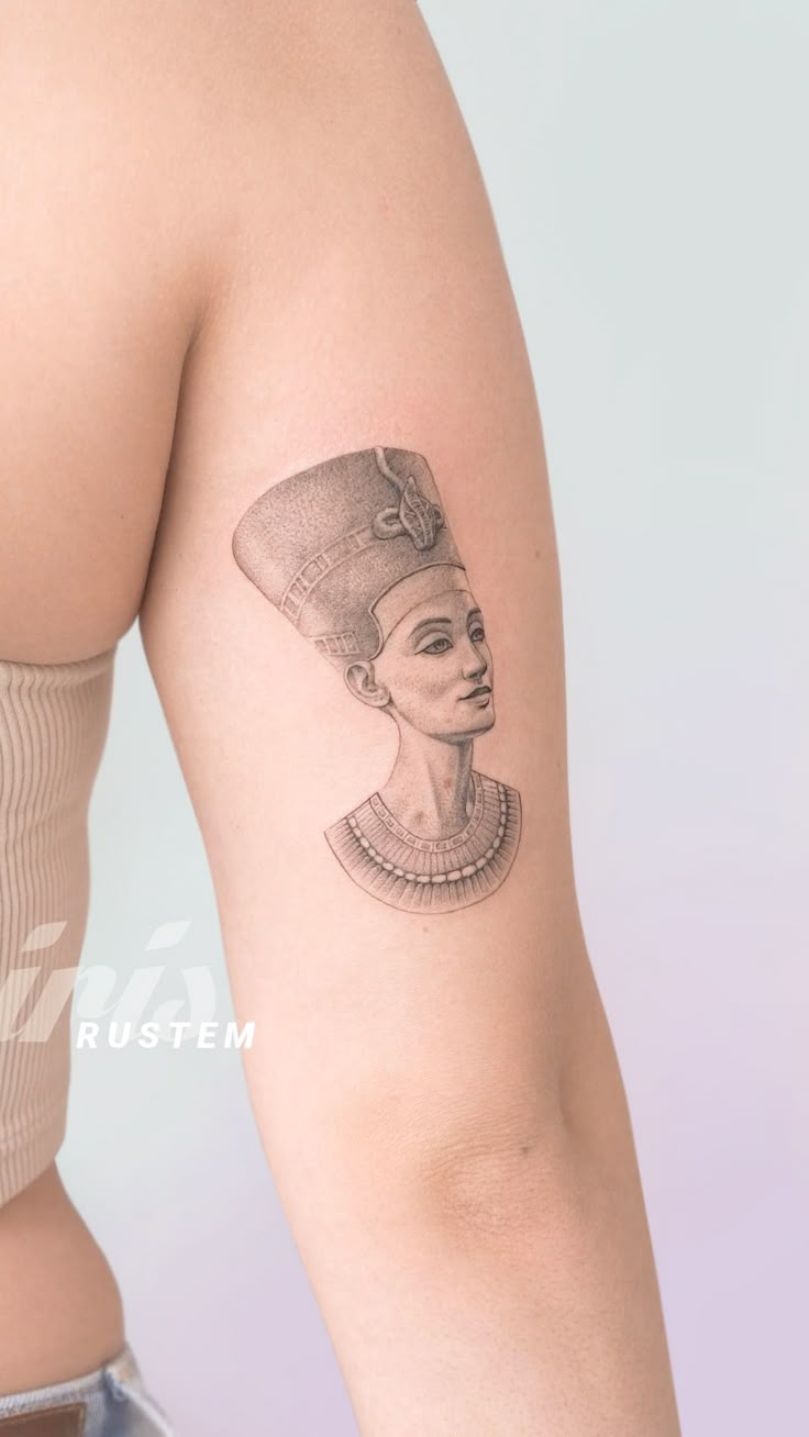 a woman's arm with a tattoo on it that has an egyptian queen head