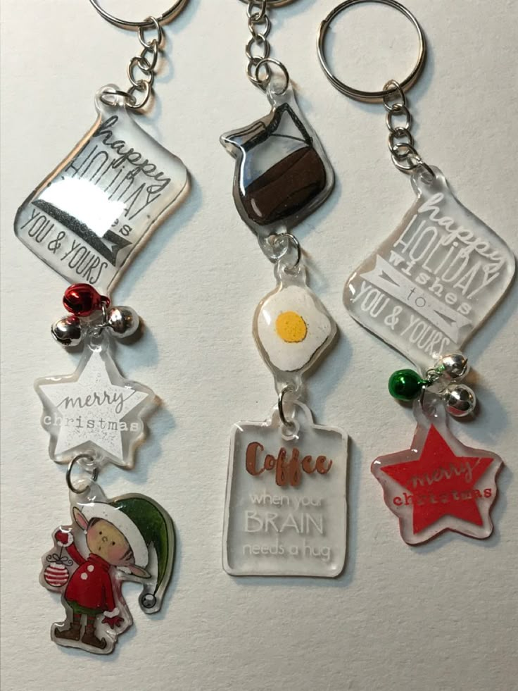 four different key chains with charms attached to them