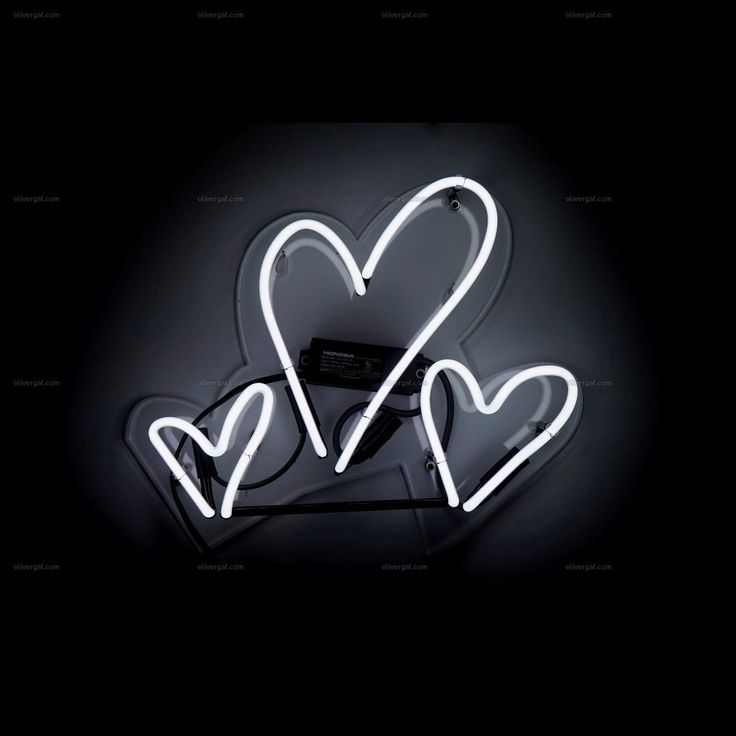 a neon sign with two hearts on it's side and the word love spelled in white