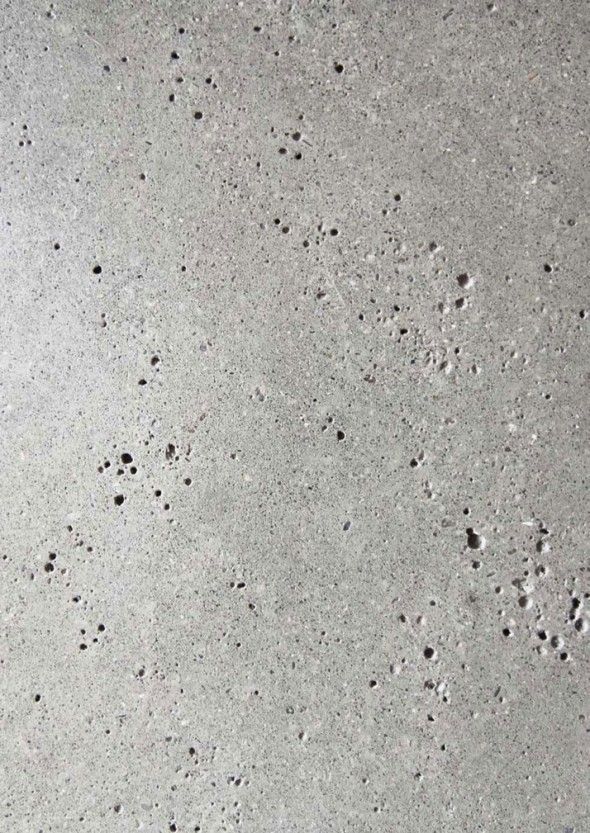 the texture of concrete is white and gray with black dots on it, as well as small holes in the cement