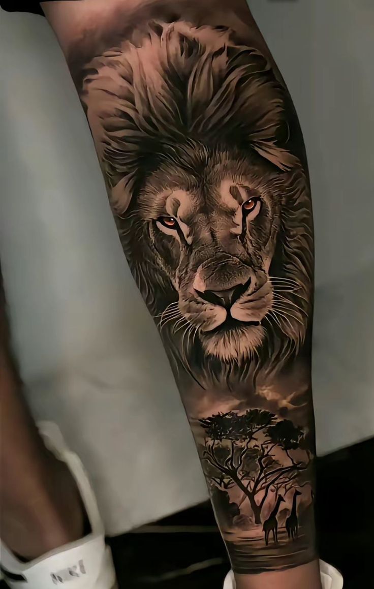 a man's leg with a lion tattoo on it