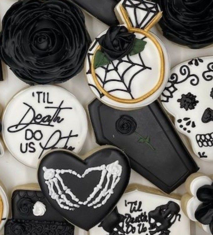 decorated cookies with black and white icing are arranged in the shape of hearts, roses, and handwritten words