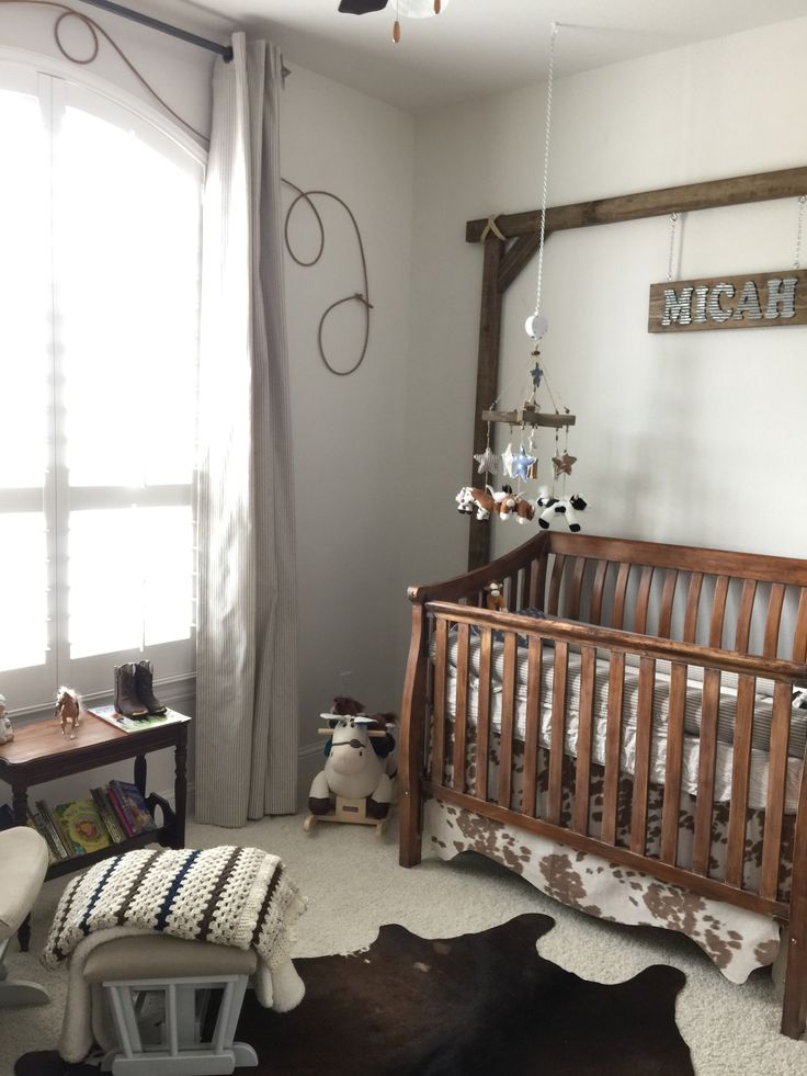 a baby's room with a crib, rocking horse and other items on the floor