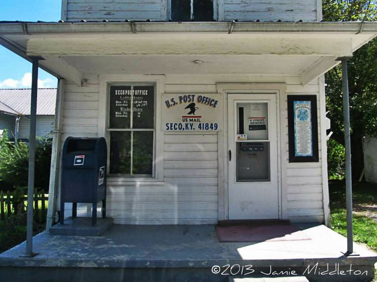 a small white building with an old pay phone