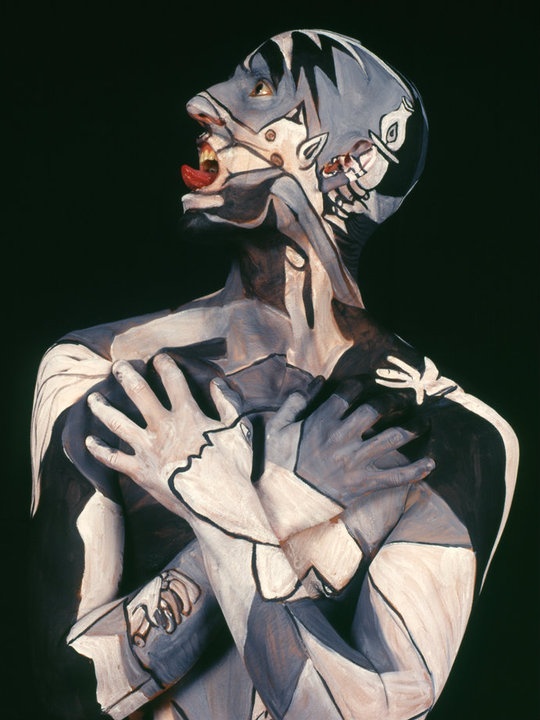 a painting of a man with his hands on his chest and face painted like a skeleton