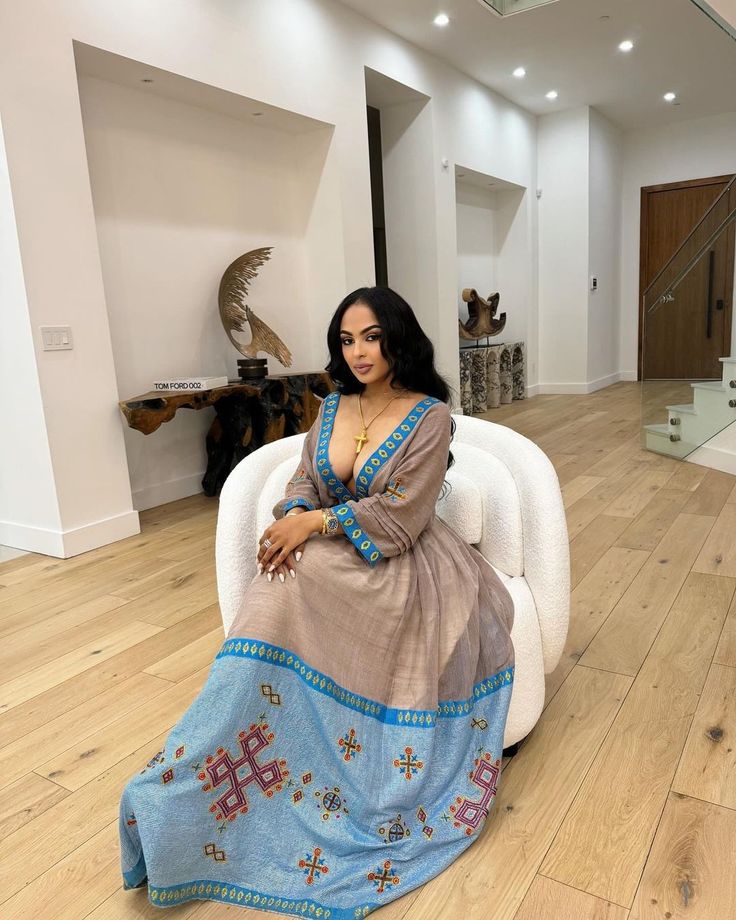 Indulge in the timeless beauty of this modern Ethiopian dress, adorned with an exquisite blue wide tile design. Its intricate embroidery and delicate craftsmanship create a captivating and sophisticated look. Perfect for special occasions or as a statement piece, this dress is a celebration of Ethiopian artistry and will leave a lasting impression. Material Cotton Thread Estimated delivery : 2 weeks to 4 weeks Contact WhatsApp +1(304)-306-2784Email: contact@ethiopian.store Ethiopian Dress Style, Ethiopian Dress Modern 2022, Ethiopian Dress Modern, Somali Dress, Habesha Clothes, Ethiopian Dresses, Ethiopian Traditional Dress, Ethiopian Women, Ethiopian Dress