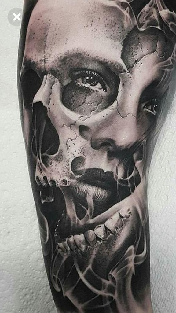 a man with a skull tattoo on his leg