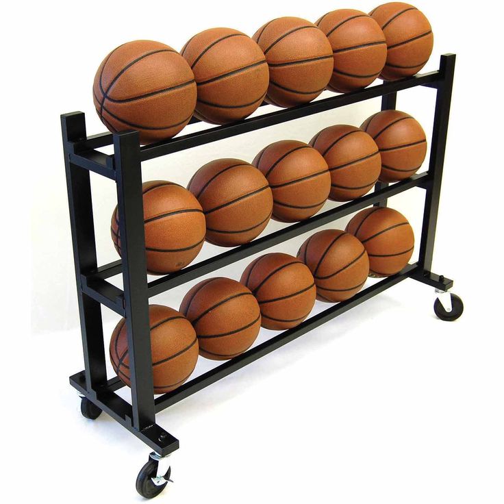 a rack filled with basketballs sitting on top of a white floor