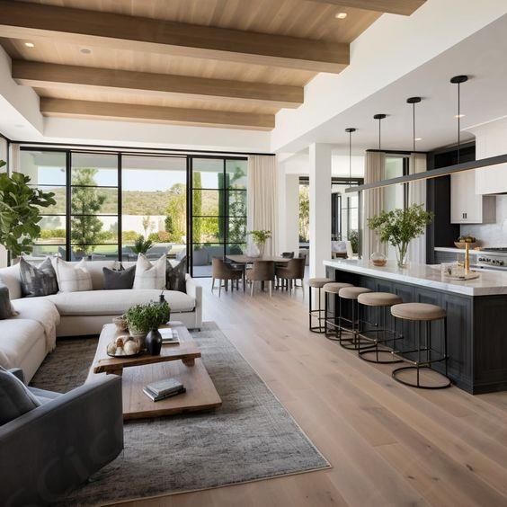 a living room filled with furniture next to a kitchen and an open concept dining area