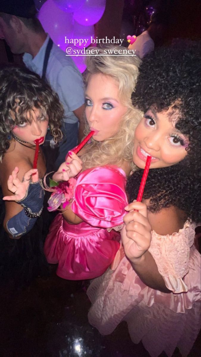 three women dressed up as barbie dolls holding lollipops in front of them