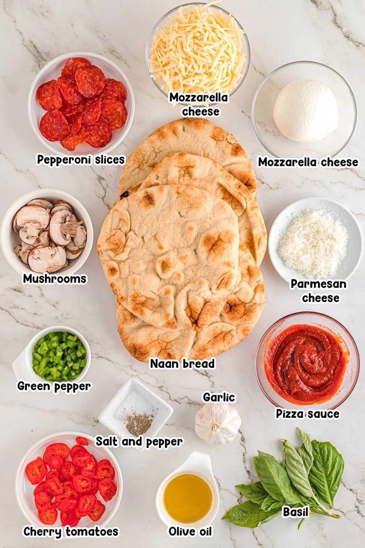 the ingredients to make an italian pizza laid out on a white marble countertop with text overlay