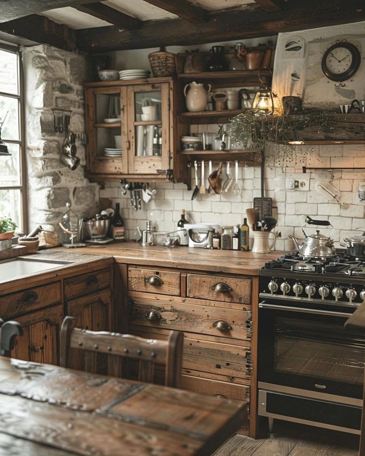 an old fashioned kitchen with wooden cabinets and wood table in the center, along with a clock on the wall