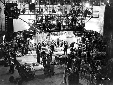 an old black and white photo of some people in front of a stage with lights