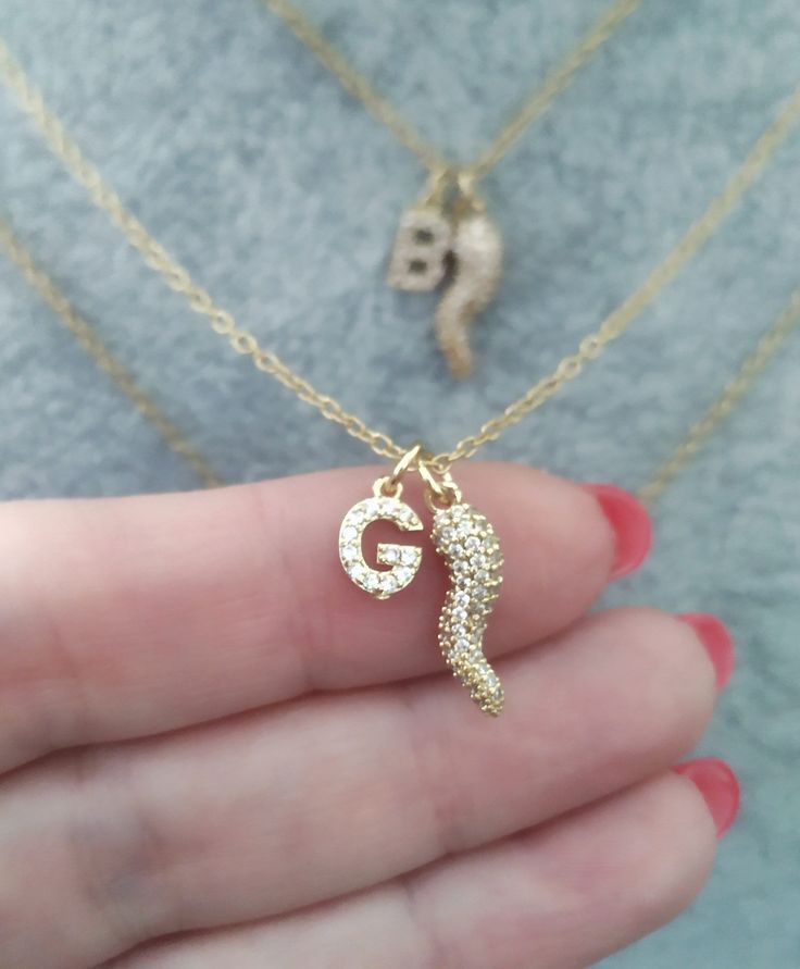 This is a dainty personalized Italian Horn Necklace with Small Paved Initial Letter Pendants which makes a perfect Italy Women Girl Gift.  This is a unique and beautiful necklace with Italian Horn and Hand charms personalized with initial letter.  It makes a beautiful and thoughtful gift for your loved ones. The necklace is 14k gold plated brass. Our gold plated jewelry is coated with protective lacquer, but always keep in mind that these are not fine metals - avoiding contact with perfumes, creams, salt water and other elements will help to keep the beauty of your item Please read our frequently asked questions FAQ to find out more. Delicate Pendant Charm Necklace For Personalized Gift, Personalized Pendant Charm Necklace With Delicate Chain, Gold Dangle Necklaces For Personalized Gifts, Personalized Pendant Necklace With Delicate Chain, Personalized Gift Clavicle Chain Charm Necklace, Dainty Clavicle Chain Necklace For Personalized Gift, Personalized Dainty Clavicle Chain Necklace, Personalized Pendant Necklace With Lobster Clasp, Cornicello Necklace