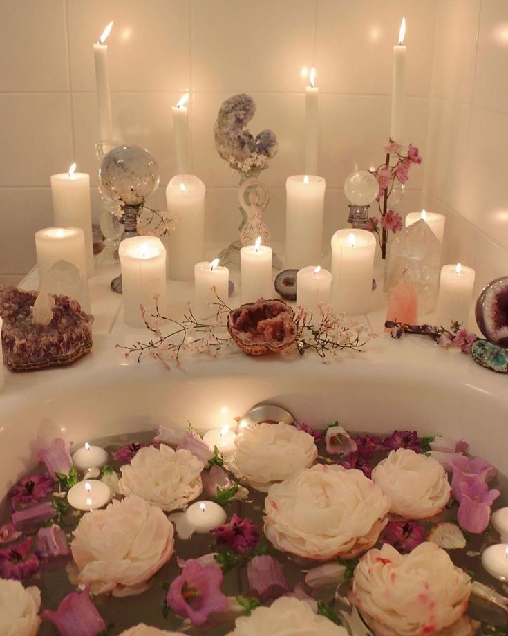 cupcakes in a bathtub with candles and flowers on the side for decoration