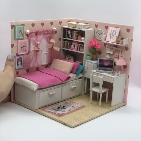 a dollhouse bedroom with a bed, desk and bookcase in the corner is shown