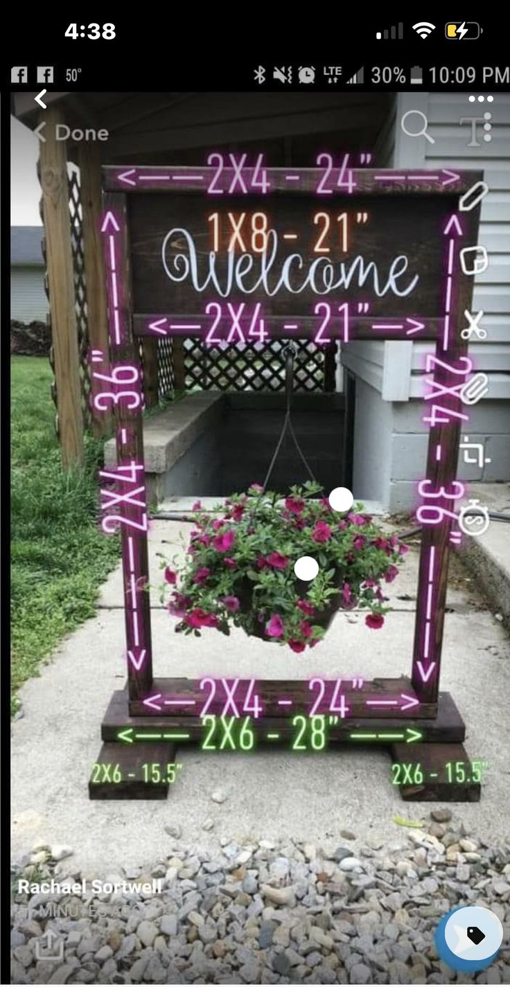 a welcome sign with pink flowers in it