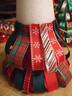 a roll of ribbon sitting on top of a wooden table next to christmas tree ornaments