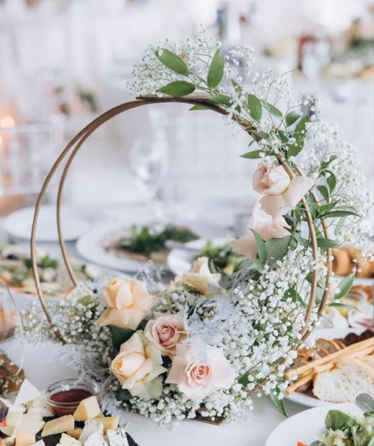 the table is set with flowers and desserts