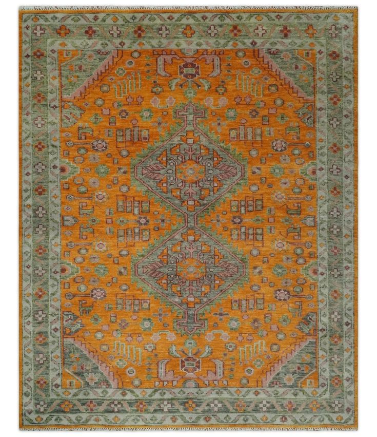 an orange and green rug with many different designs on it's sides, including the center