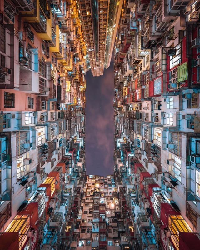 an aerial view of a city with tall buildings and lots of windows in the middle