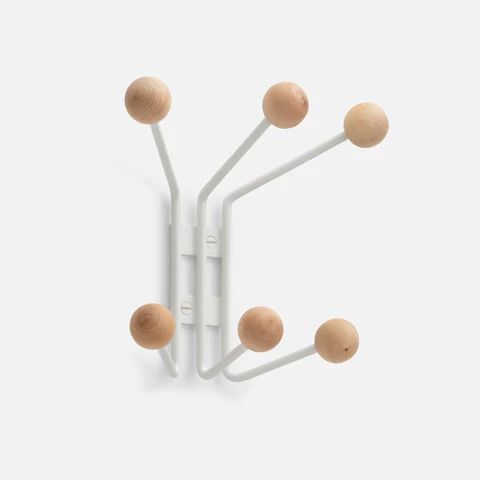 three white hooks with wooden balls attached to them