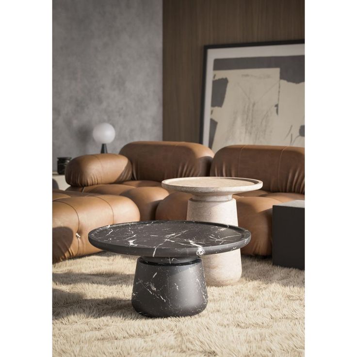 a living room with leather couches and marble coffee table in the middle, surrounded by sheepskin rugs