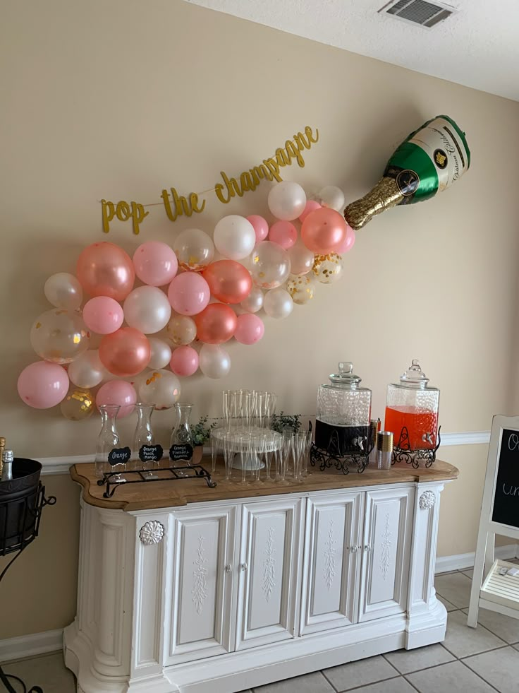 a champagne bar with balloons and streamers on the wall