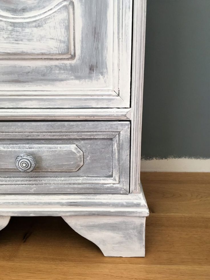 an old white painted dresser with drawers and knobs