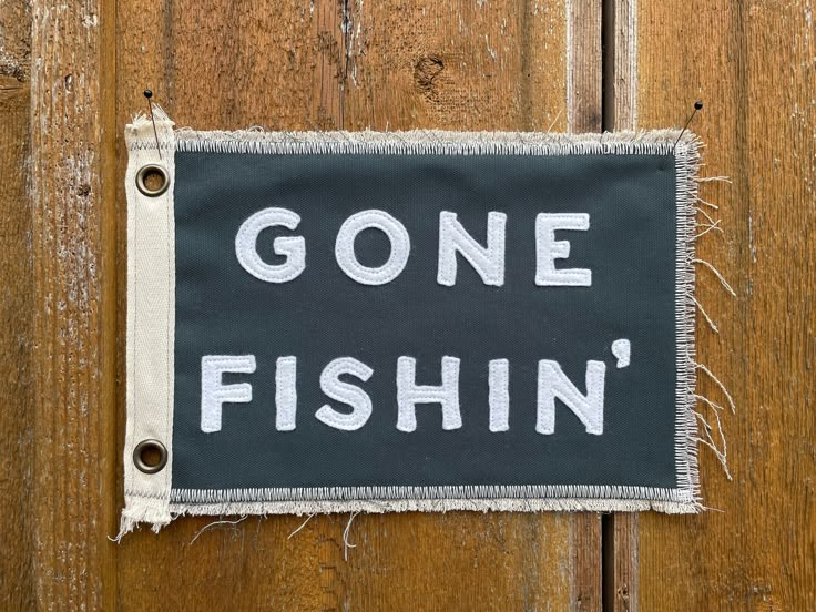 a black and white sign that says gone fishin'on the side of a wooden door